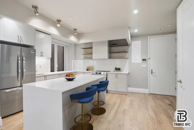 a kitchen with a sink a refrigerator and a stove