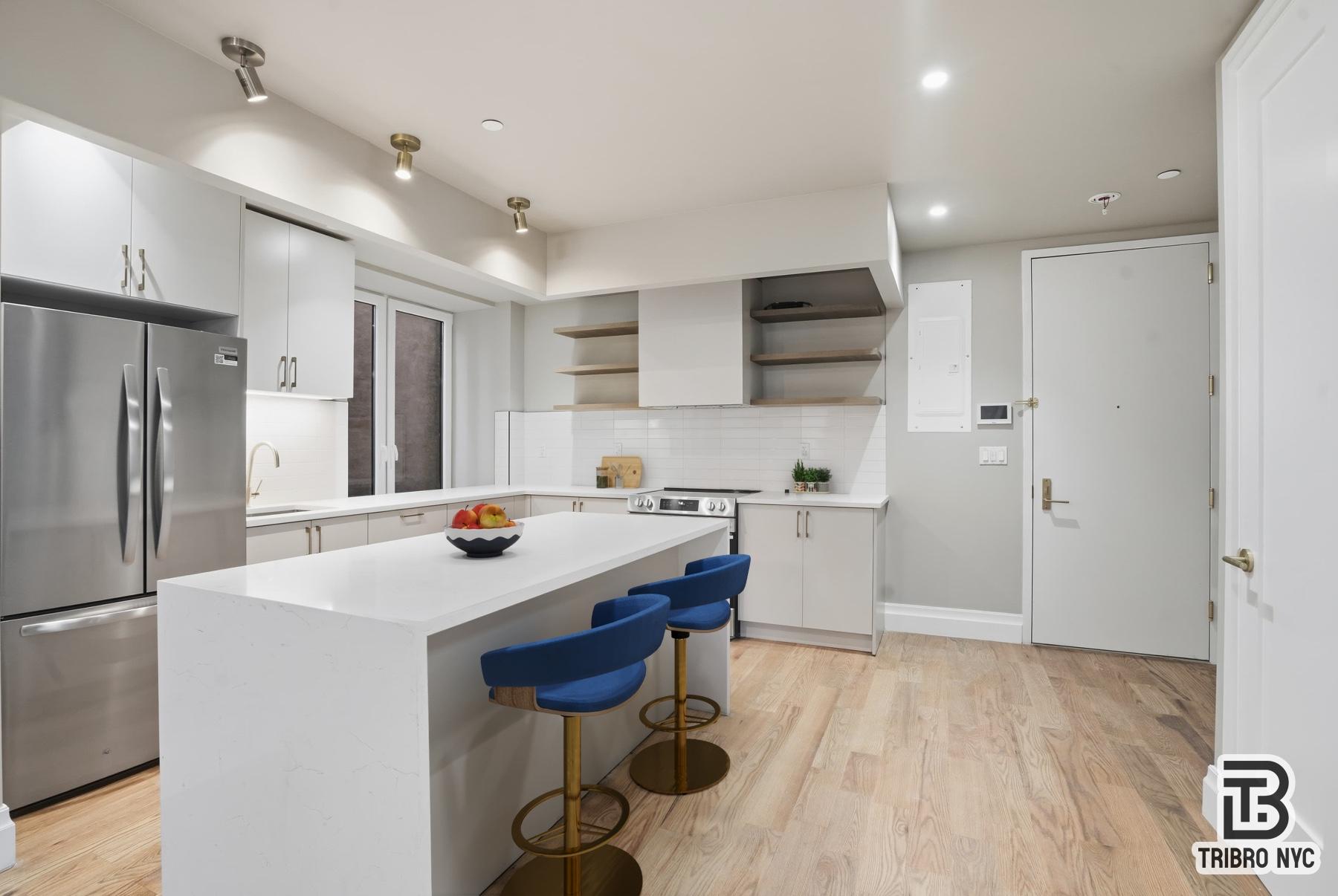 129 Russell Street, Unit 1D Brooklyn, NY 11222 - Photo 2 of 13 a kitchen with a sink a refrigerator and a stove