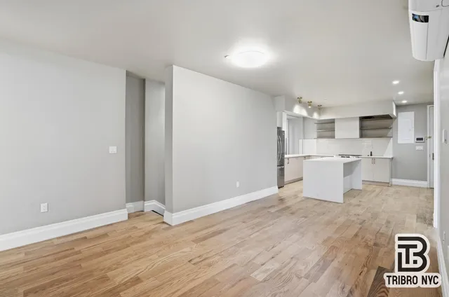 a view of a kitchen with wooden floor and a sink