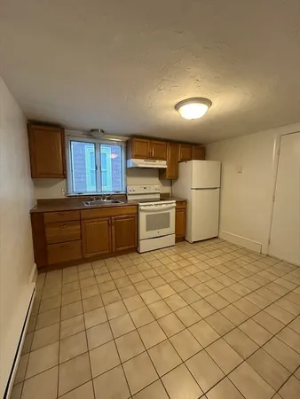 a kitchen with a cabinets and a refrigerator