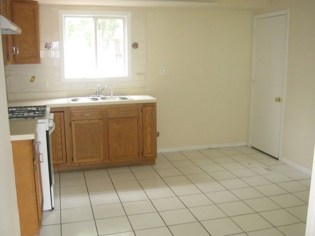 532 Spruce Road Bolingbrook, IL 60440 - Photo 6 of 21 a view of a kitchen with white cabinets