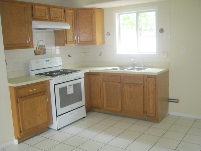 532 Spruce Road Bolingbrook, IL 60440 - Photo 7 of 21 a kitchen with a stove sink and cabinets
