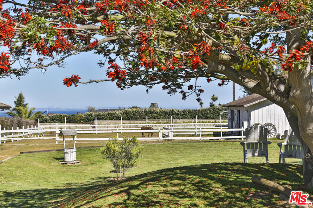 7016 Dume Drive Malibu, CA 90265 - Photo 14 of 24 a view of a swimming pool with an outdoor space and seating area
