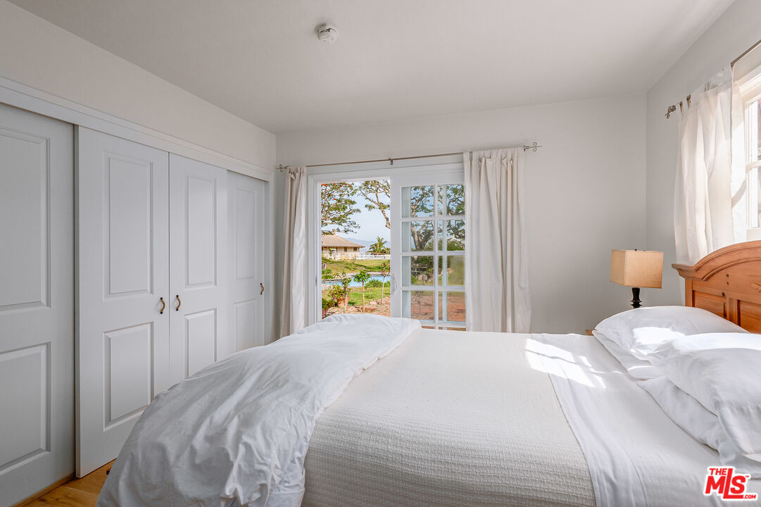 7016 Dume Drive Malibu, CA 90265 - Photo 17 of 24 a bedroom with a bed and a window