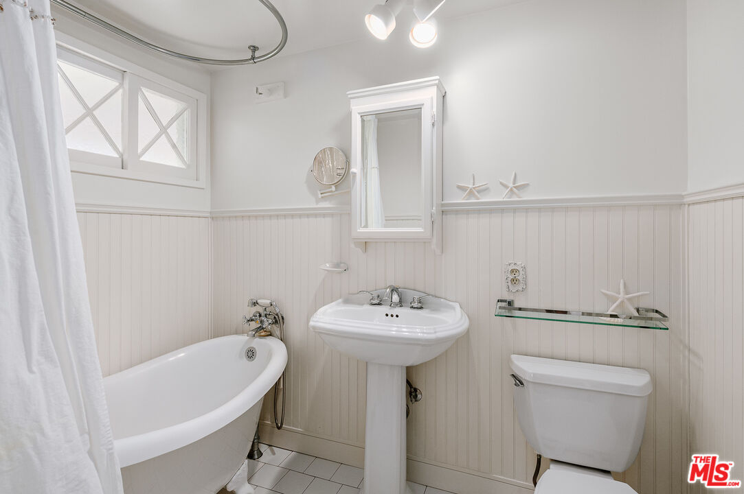 7016 Dume Drive Malibu, CA 90265 - Photo 18 of 24 a bathroom with a sink a toilet and mirror