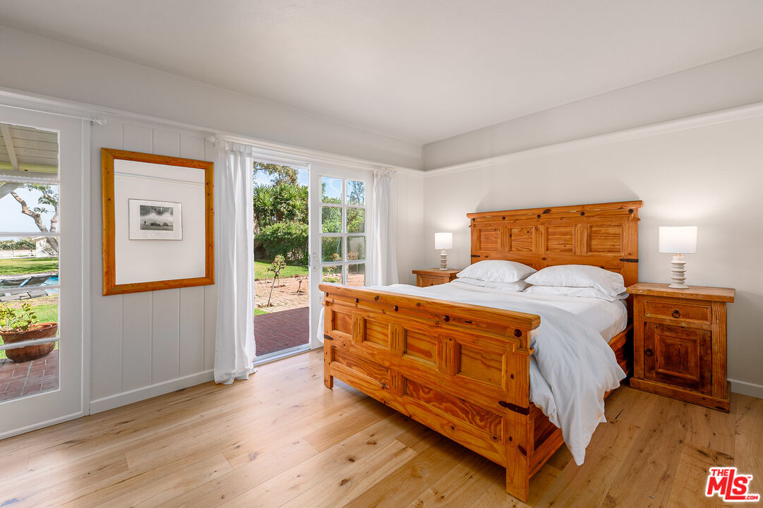 7016 Dume Drive Malibu, CA 90265 - Photo 19 of 24 a large bed sitting in a bedroom next to a window