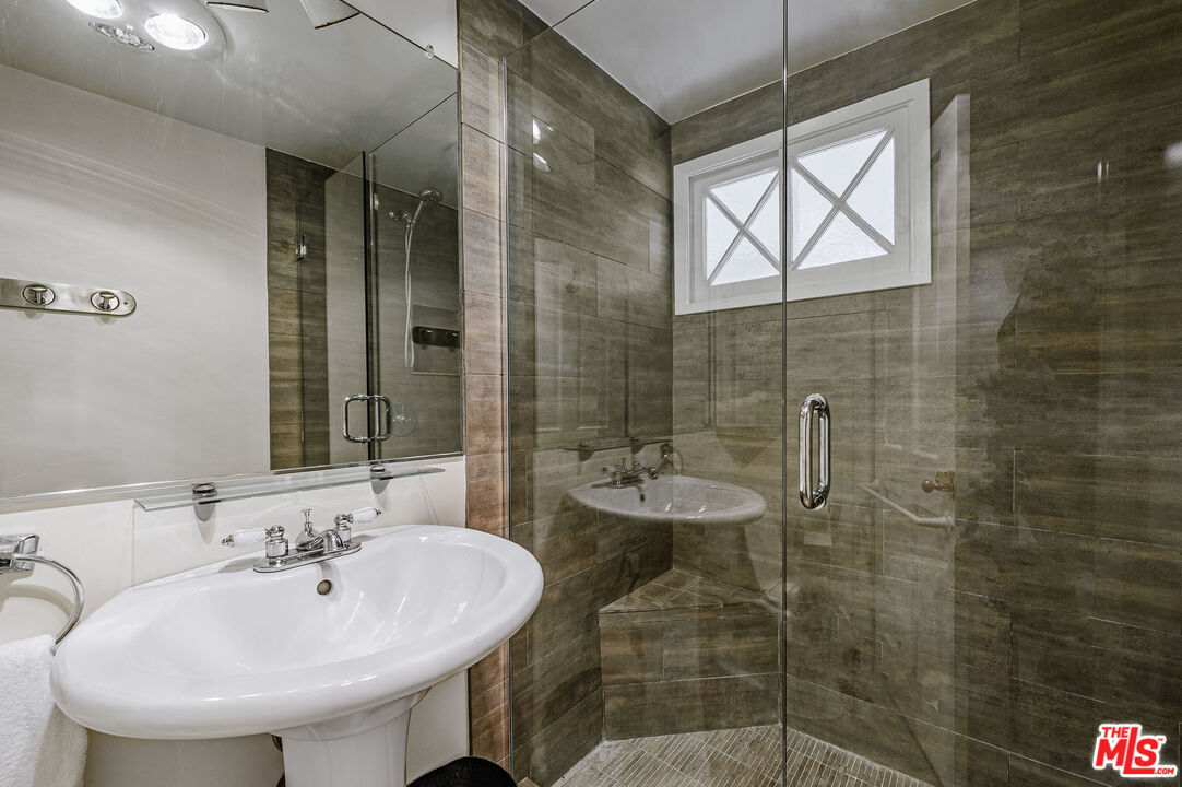 7016 Dume Drive Malibu, CA 90265 - Photo 21 of 24 a bathroom with a sink and a mirror