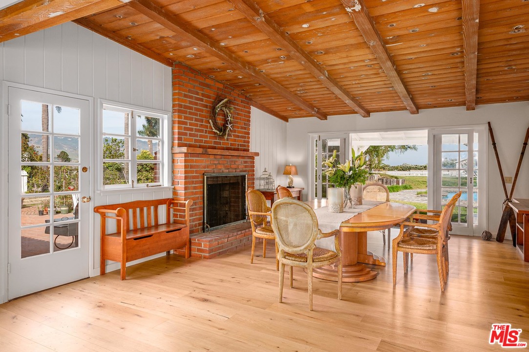 7016 Dume Drive Malibu, CA 90265 - Photo 4 of 24 a living room with furniture a fireplace and wooden floor