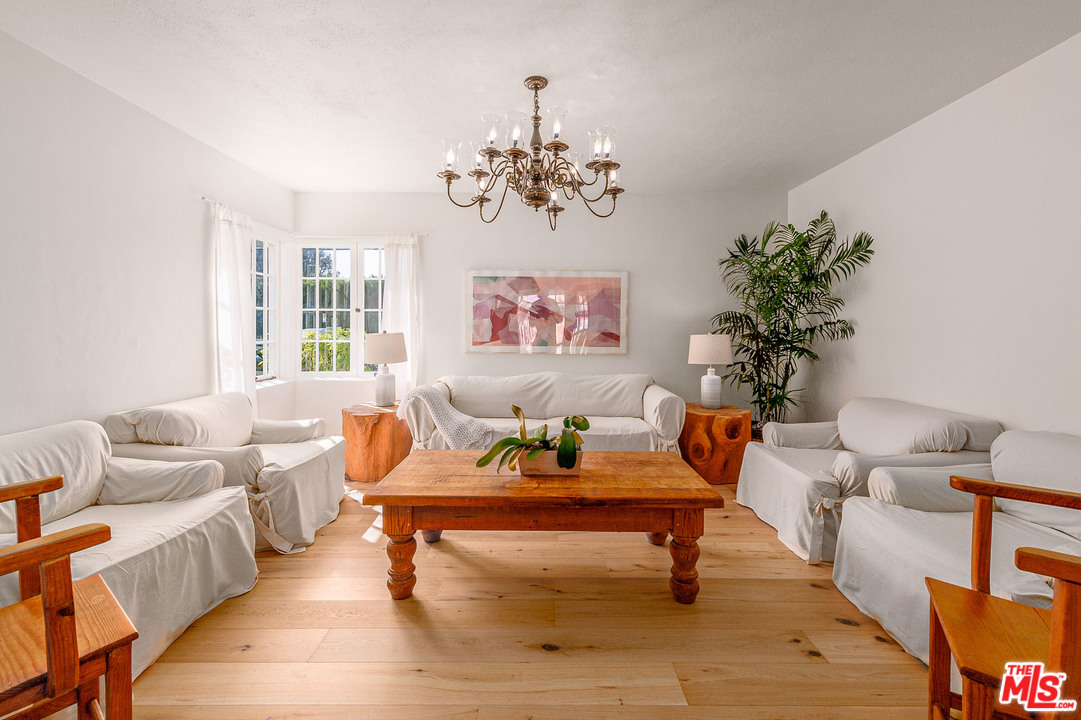 7016 Dume Drive Malibu, CA 90265 - Photo 5 of 24 a living room with furniture chandelier and a window