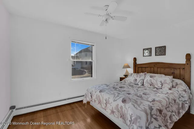 a bedroom with a bed and a painting on the wall