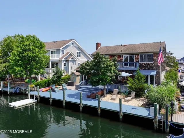 a view of house with yard outdoor seating and lake view