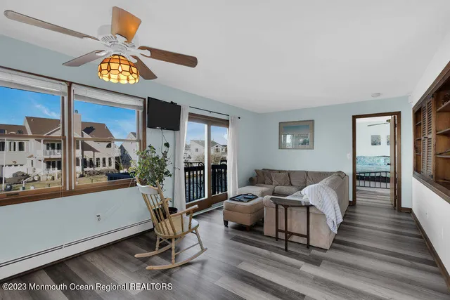a living room with furniture and a floor to ceiling window