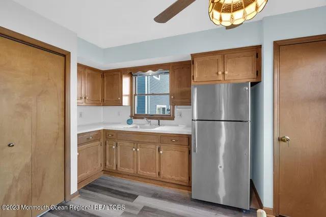 a kitchen with a refrigerator sink and cabinets