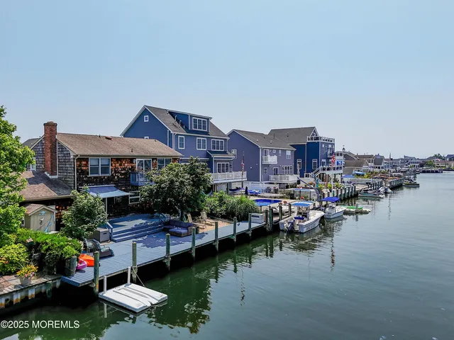 a view of a lake with a house swimming pool and outdoor seating