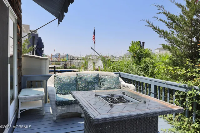 a patio with wooden floor table and chairs