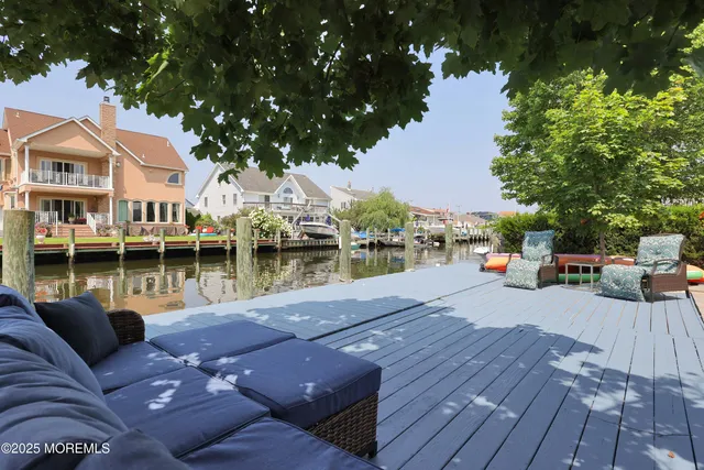 a view of a patio with chairs next to a lake
