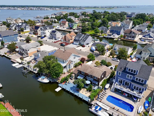 an aerial view of multiple house with a lake view