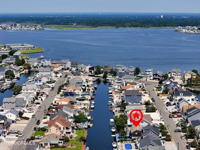 an aerial view of a house with lake view