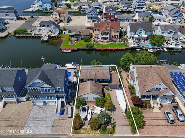 a view of a house with porch and wooden fence