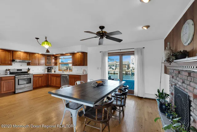 a kitchen with a table chairs stainless steel appliances and cabinets