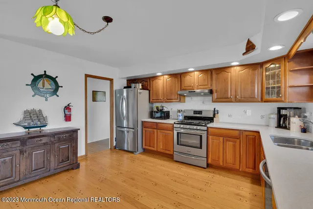 a kitchen with stainless steel appliances granite countertop a sink and a stove