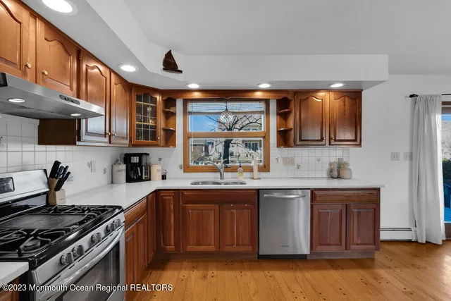 a kitchen with stainless steel appliances granite countertop a stove and a sink