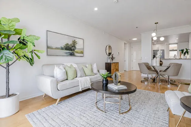 a living room with furniture and a potted plant