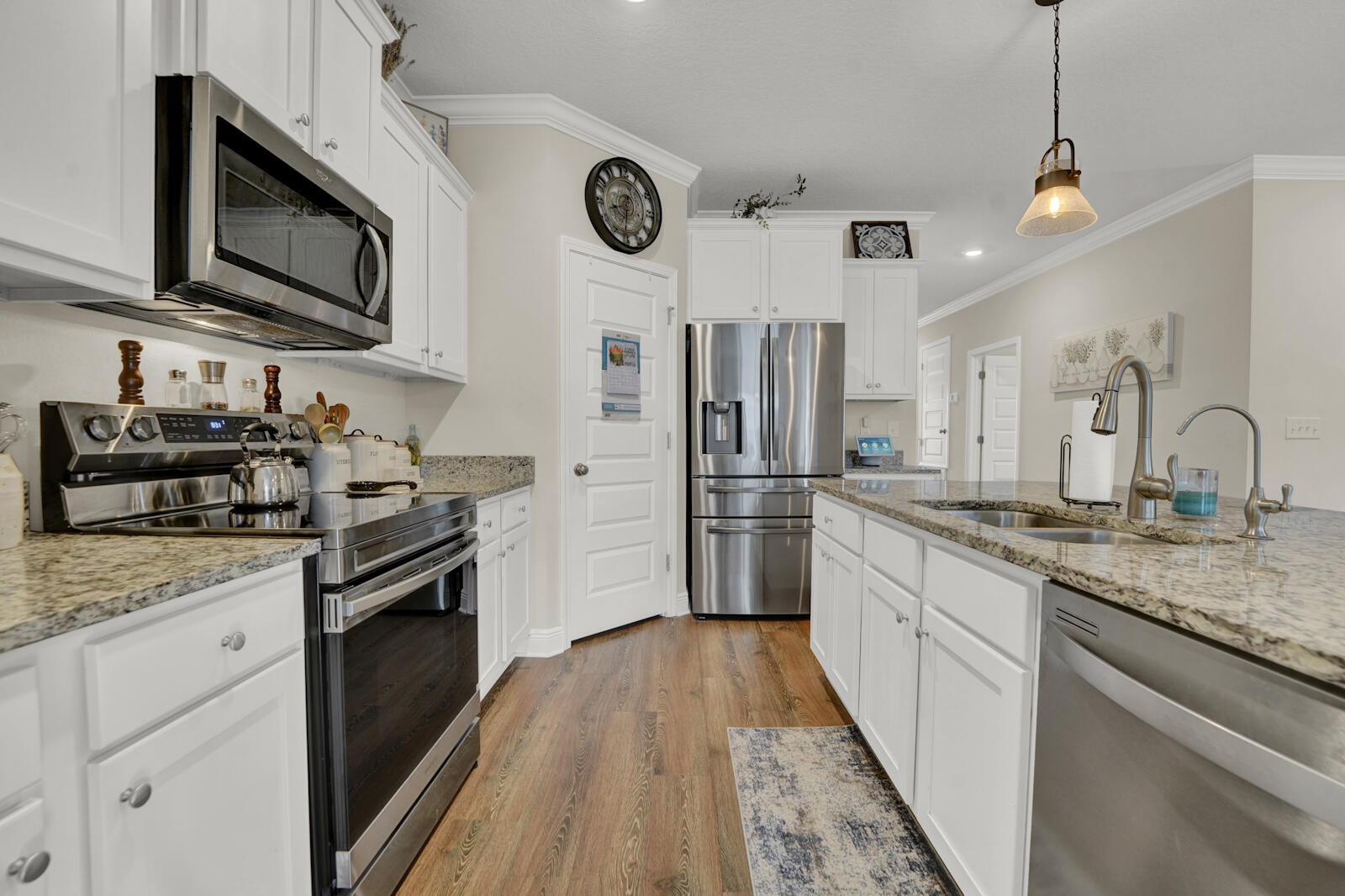 412 Lightning Bug Lane Freeport, FL 32439 - Photo 13 of 52 a kitchen with stainless steel appliances granite countertop a stove a sink and a refrigerator