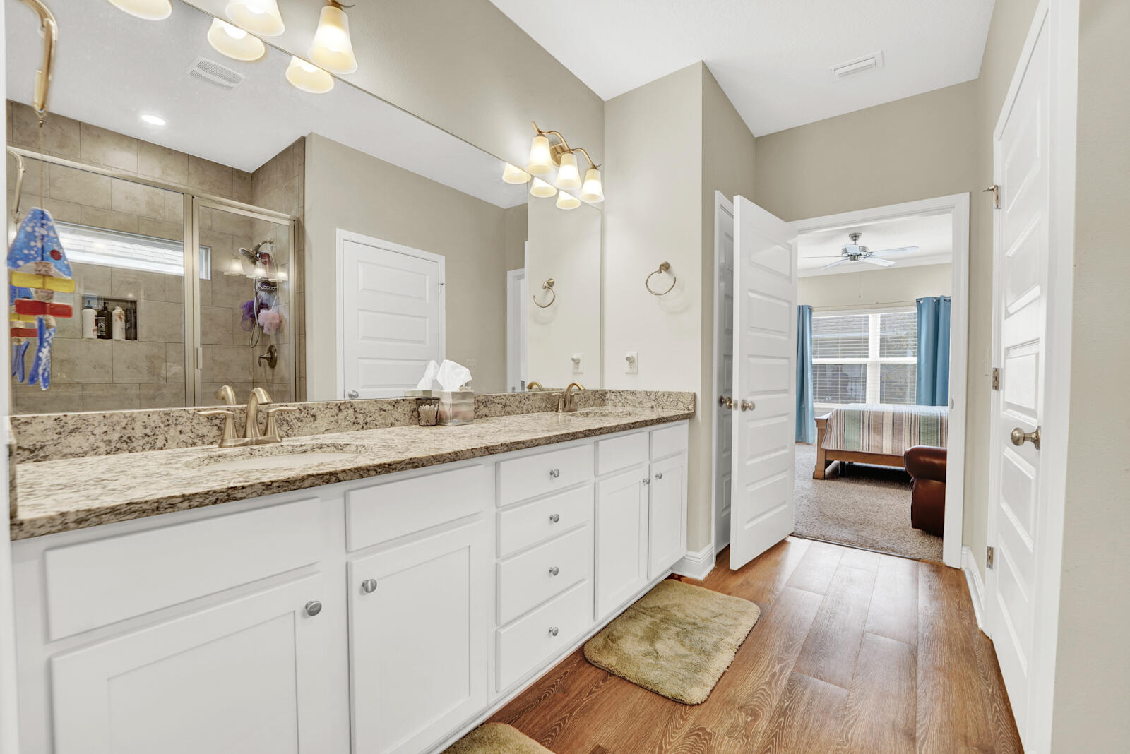 412 Lightning Bug Lane Freeport, FL 32439 - Photo 22 of 52 a spacious bathroom with a granite countertop double vanity sink a mirror and a