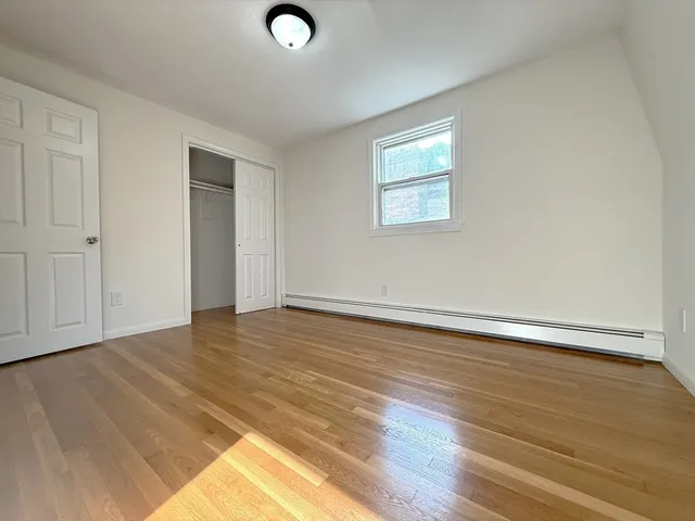 a view of an empty room and wooden floor