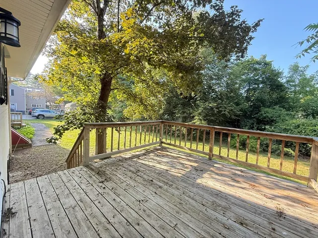 a view of balcony with wooden floor and fence