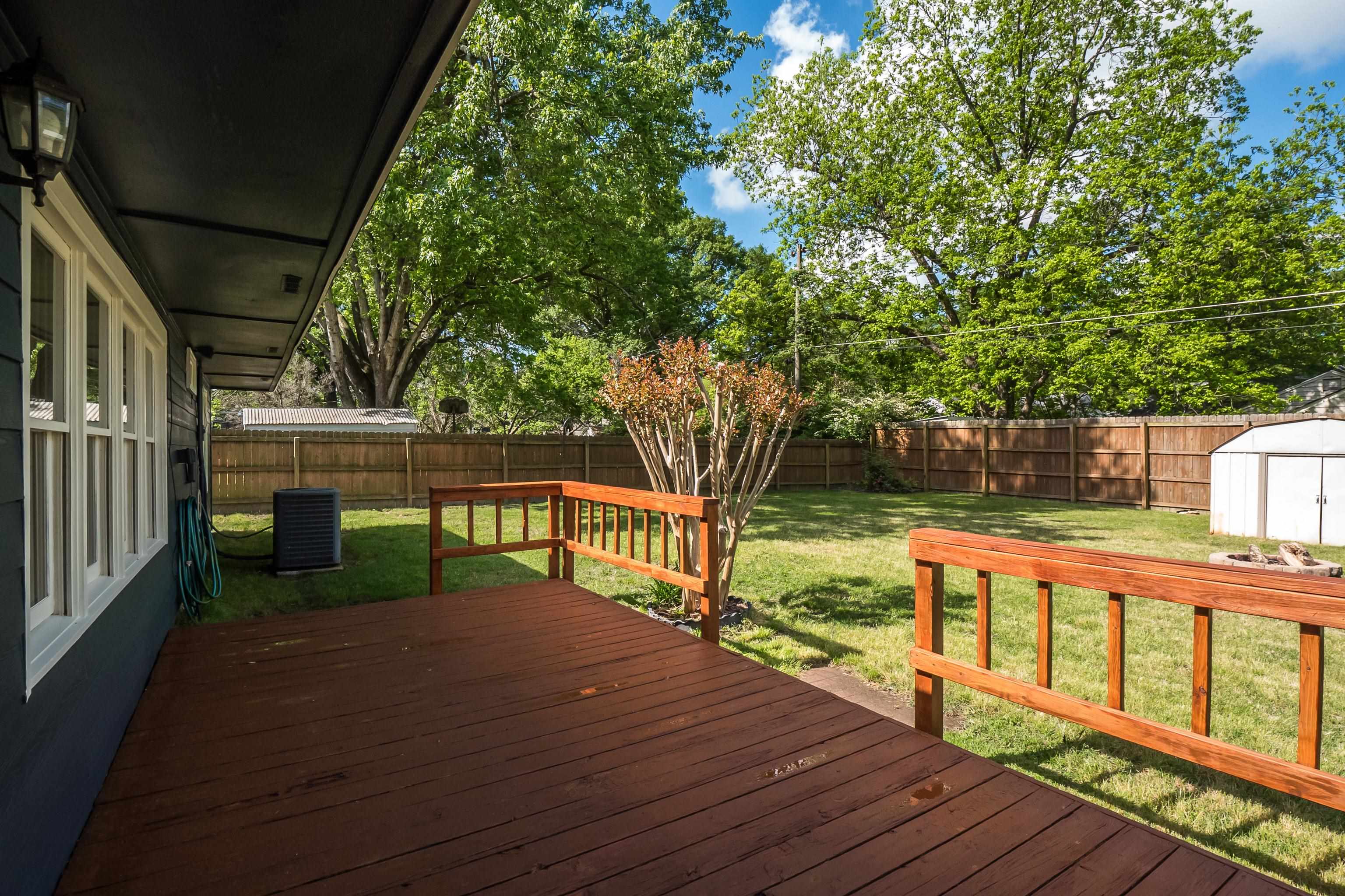 4412 Helene Road Memphis, TN 38117 - Photo 17 of 19 a view of deck with wooden floor and fence next to a yard