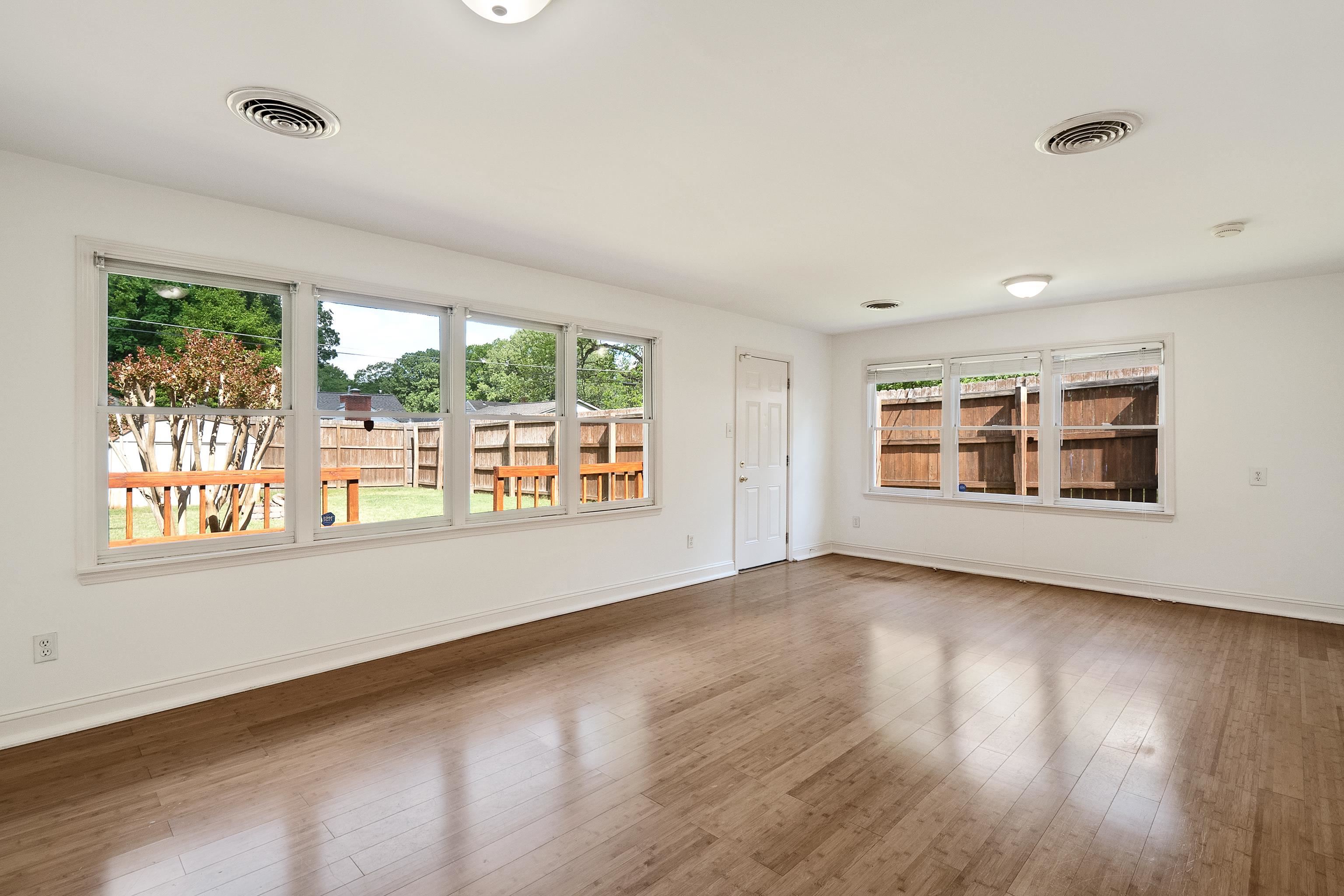4412 Helene Road Memphis, TN 38117 - Photo 6 of 19 a view of an empty room with wooden floor and a window