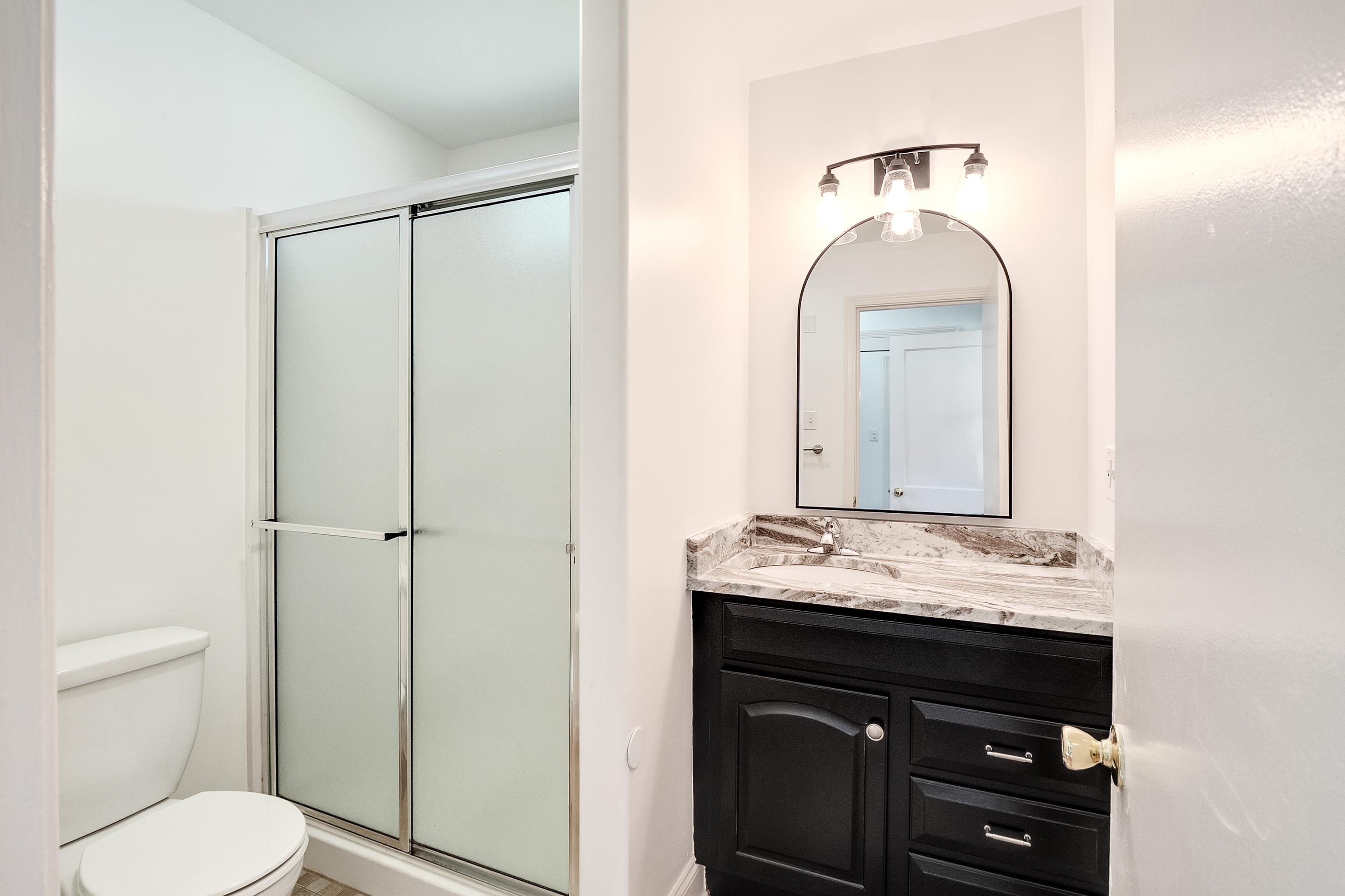 4412 Helene Road Memphis, TN 38117 - Photo 7 of 19 a bathroom with a sink a toilet and vanity