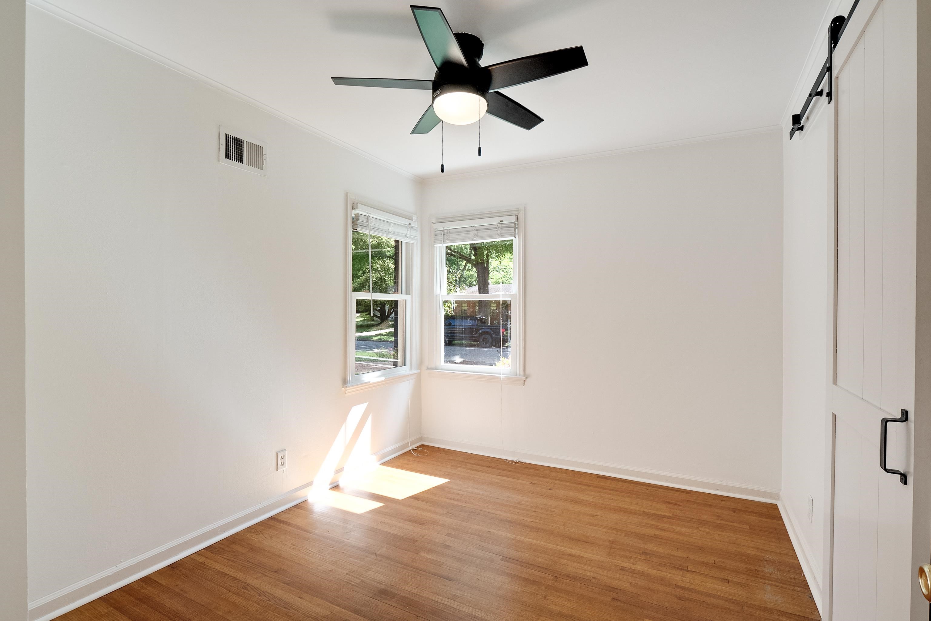 4412 Helene Road Memphis, TN 38117 - Photo 9 of 19 a view of an empty room with wooden floor and a window