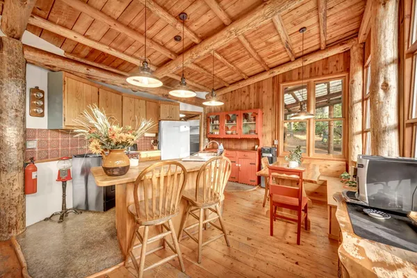 a kitchen with stainless steel appliances kitchen island granite countertop a refrigerator and a stove