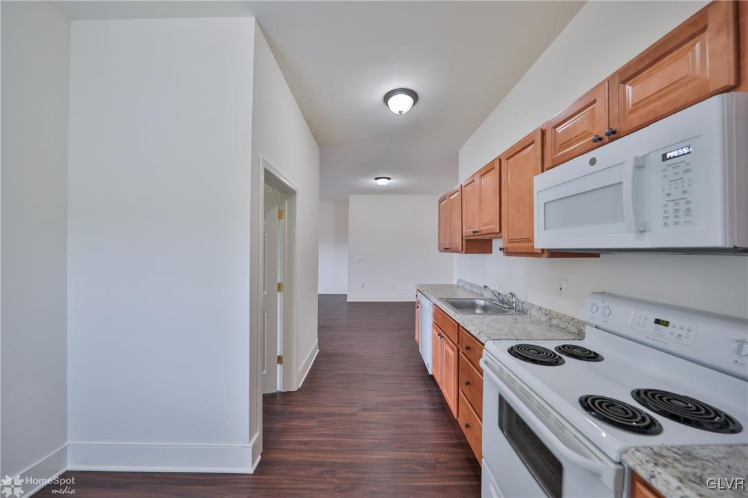 108 South Main Street, Unit 3A Alburtis, PA 18011 - Photo 13 of 35 a kitchen with a stove a sink and a refrigerator
