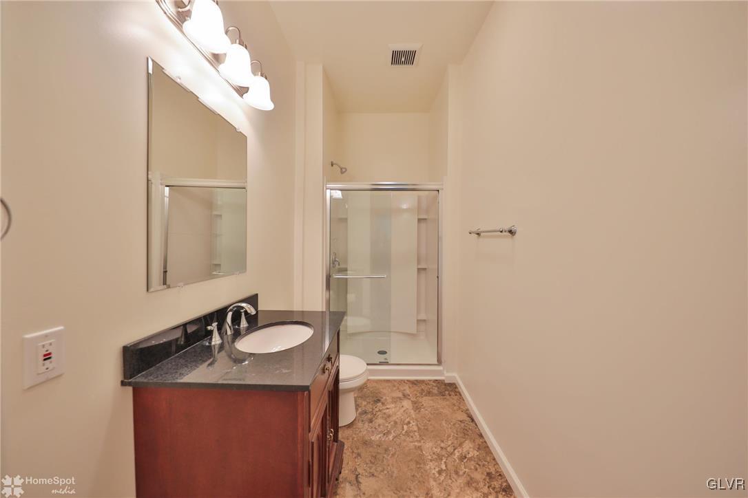 108 South Main Street, Unit 3A Alburtis, PA 18011 - Photo 14 of 35 a bathroom with a granite countertop sink toilet and shower