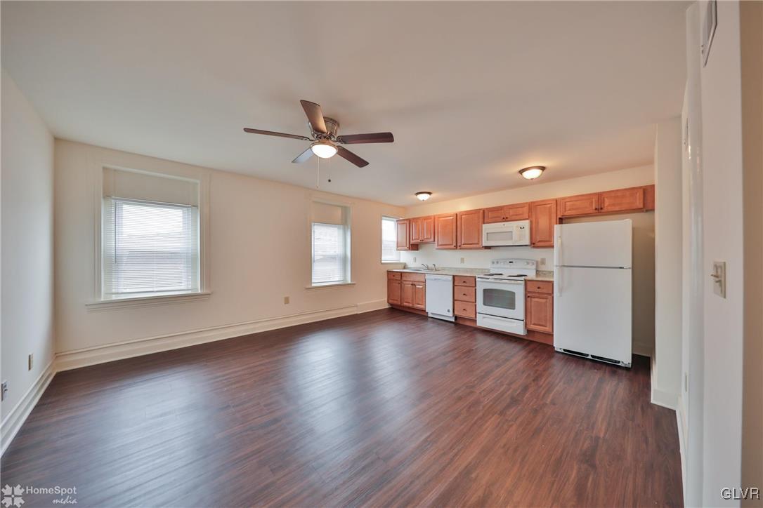 108 South Main Street, Unit 3A Alburtis, PA 18011 - Photo 16 of 35 a view of a kitchen with a sink a ceiling fan and wooden floor