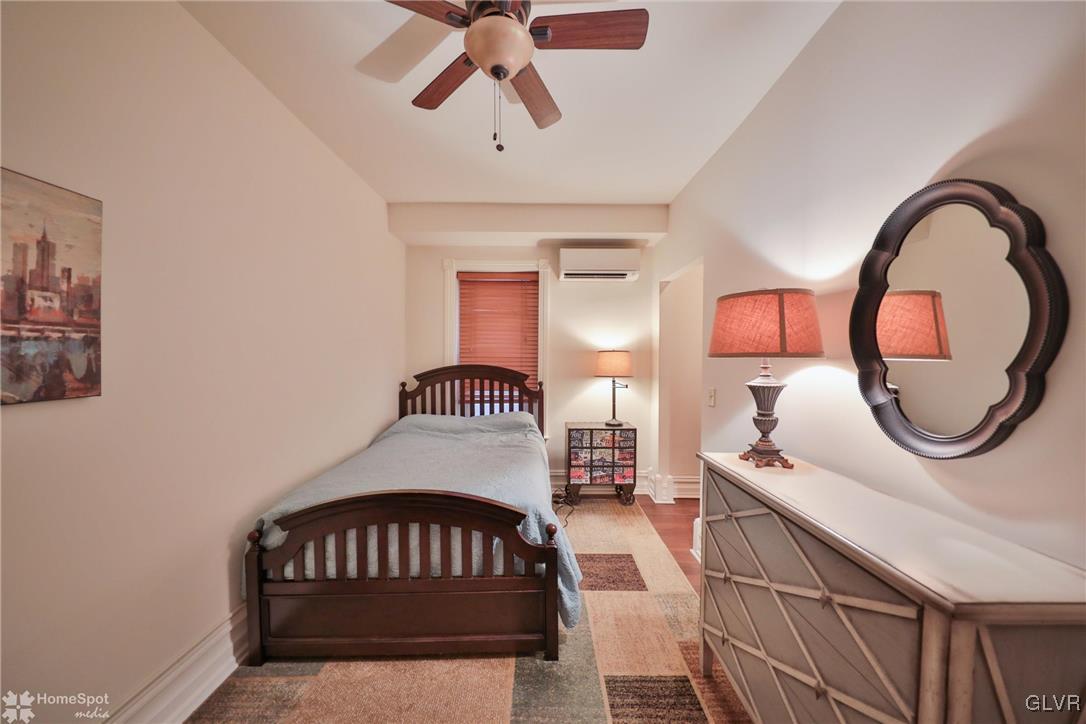 108 South Main Street, Unit 3A Alburtis, PA 18011 - Photo 21 of 35 a bedroom with a bed and dresser with mirror