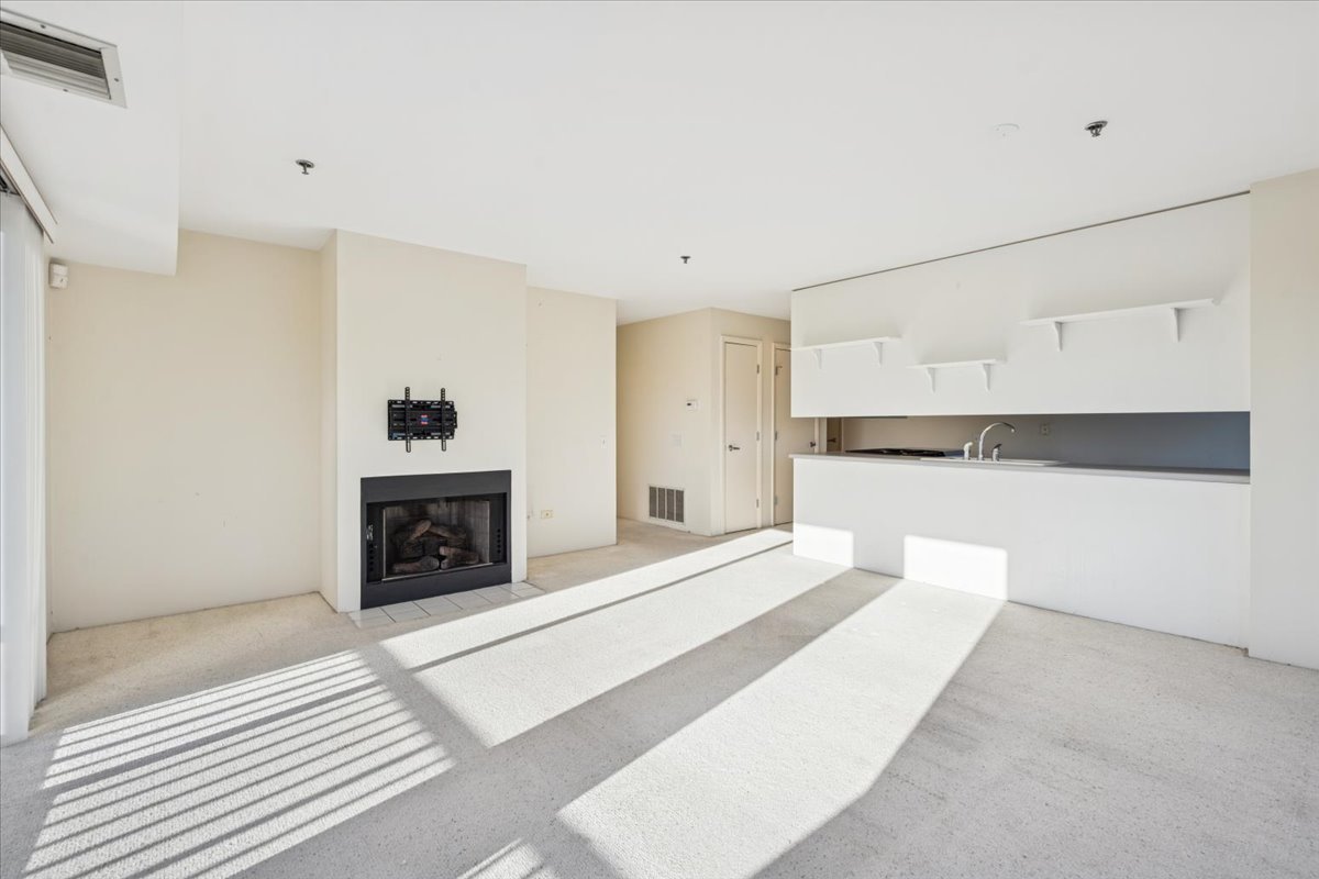 351 Kelburn Road, Unit 312 Deerfield, IL 60015 - Photo 7 of 33 a spacious bedroom with a bed and a fireplace