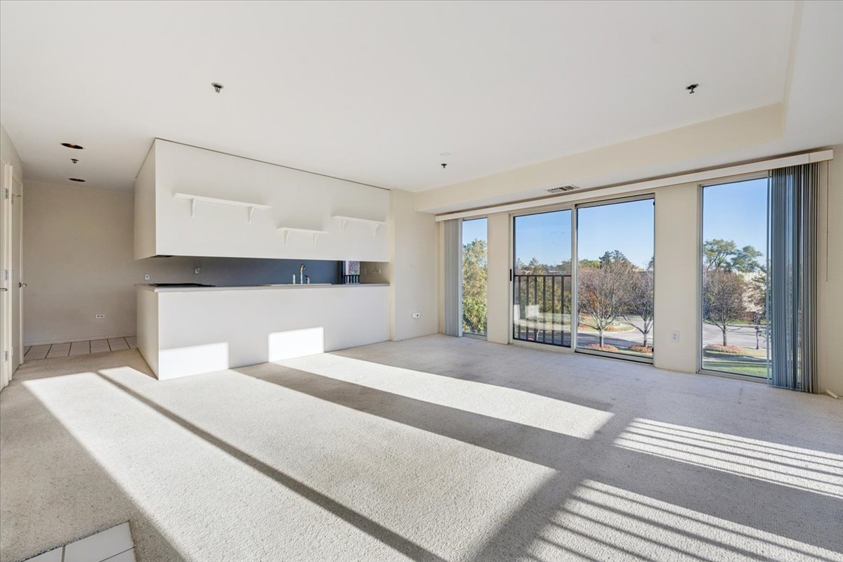 351 Kelburn Road, Unit 312 Deerfield, IL 60015 - Photo 8 of 33 a bedroom with a large bed and a large window