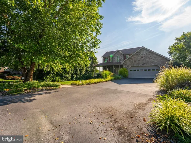 a kitchen with granite countertop a refrigerator stove top oven and sink
