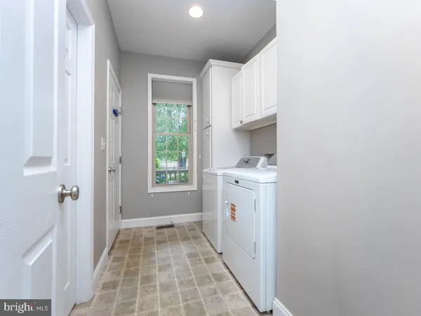 a bathroom with a granite countertop sink a toilet and a mirror
