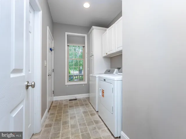 a bathroom with a granite countertop sink a toilet and a mirror
