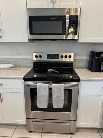 a stove top oven sitting inside of a kitchen