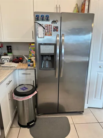 a kitchen with a refrigerator and a stove