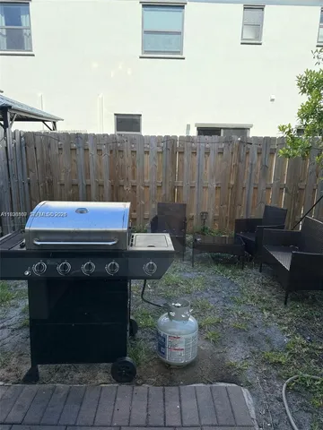 a view of a backyard with sitting area