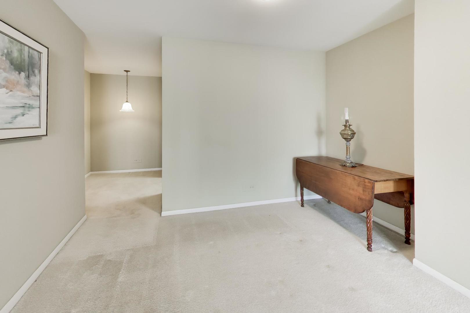 400 Ascot Drive, Unit 1M Park Ridge, IL 60068 - Photo 13 of 37 a view of a hallway with a elevator