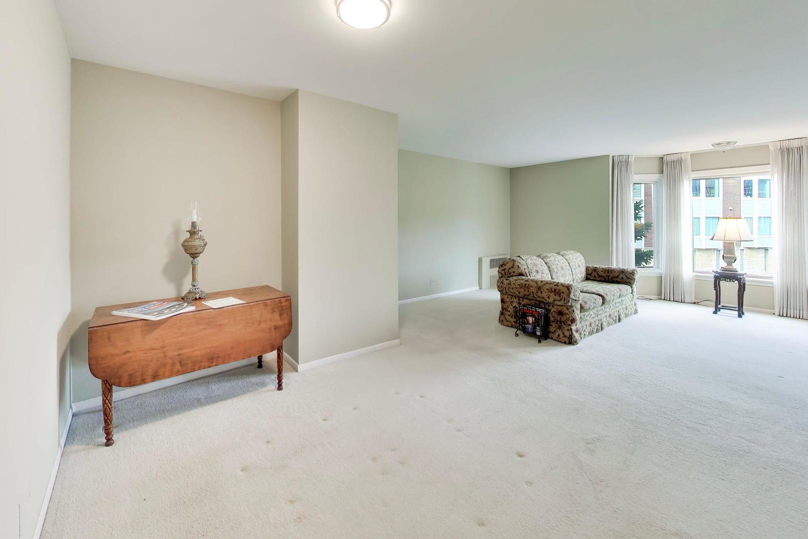 400 Ascot Drive, Unit 1M Park Ridge, IL 60068 - Photo 14 of 37 a bedroom with furniture and window